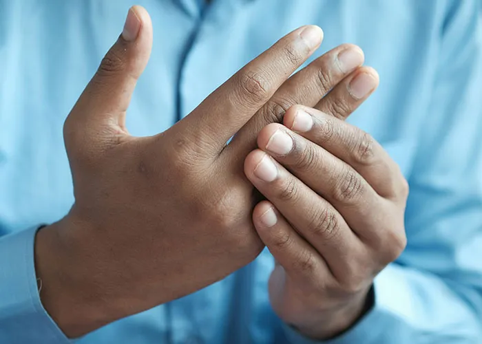 Close-up of hands with fingers touching, illustrating strange body quirks related to the fascinating human body.