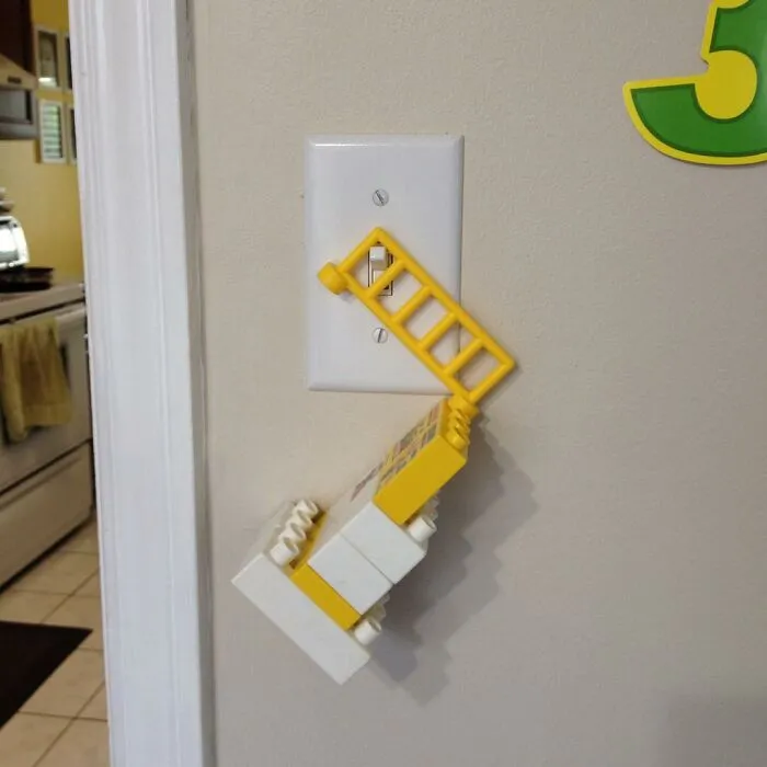 Child’s inventive LEGO creation acting as a light switch extender, showcasing kids’ surprising new inventions.