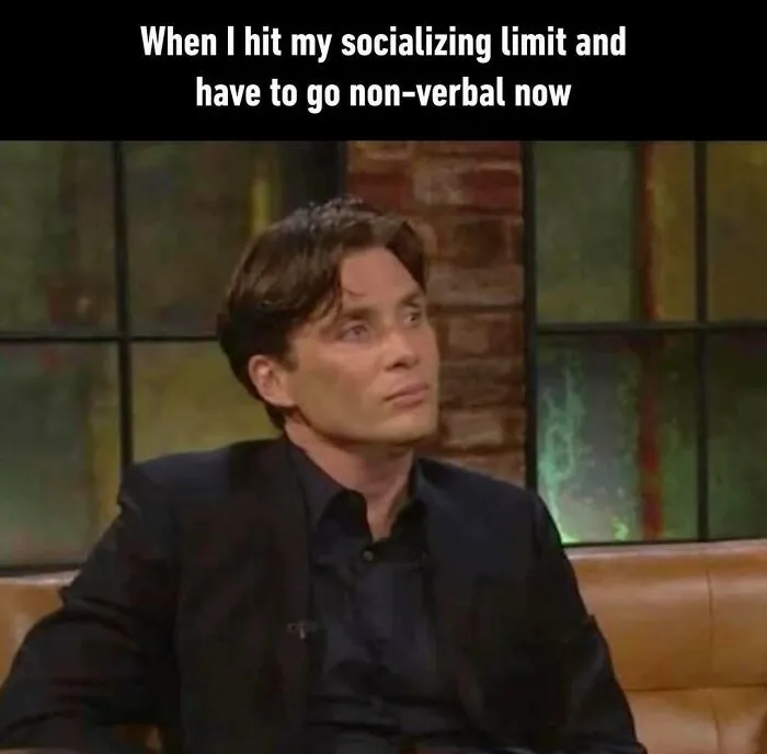 Man sitting silently with a serious expression, representing introvert memes about socializing limits and decompressing.