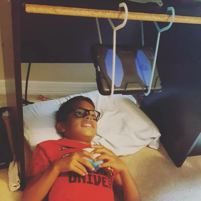 Who Needs One Of Those iPad Holder Pillows For Your Lap When You Have Two Hangers & A Desk To Lay Under?