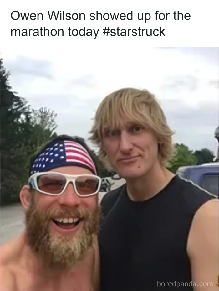 Two men posing for a selfie at a marathon, one wearing a flag headband and sunglasses, a funny celebrity lookalike moment.