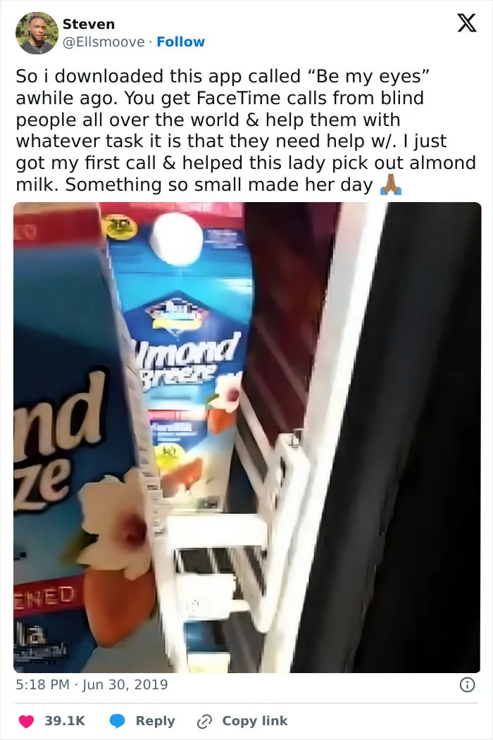 User tweet describing a heartwarming story helping a blind person choose almond milk using the Be My Eyes app.