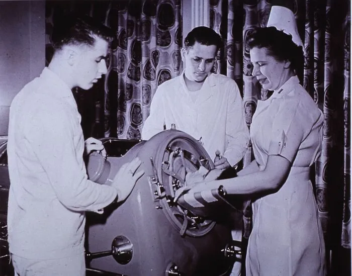A Patient Getting Treated In The Iron Lung