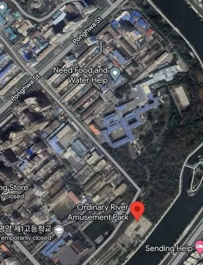 Google Earth satellite image showing an unusual location with labels like Need Food and Water Help and Ordinary River Amusement Park.