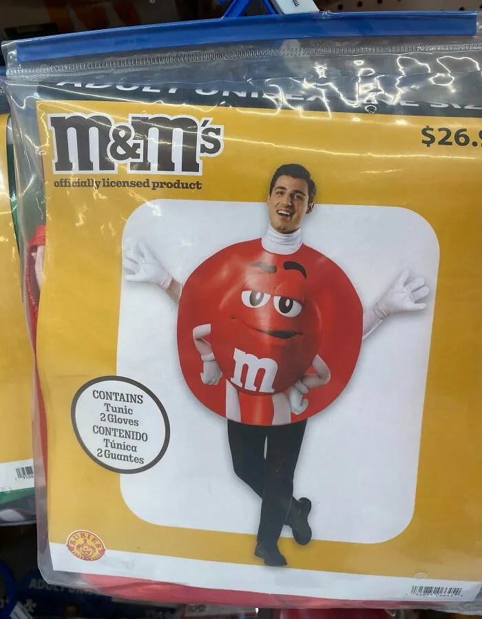Man wearing an off-brand M&M Halloween costume with a round red body and white gloves in packaging