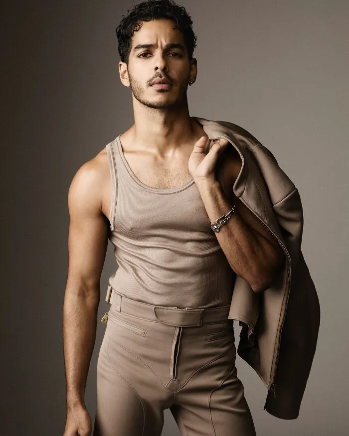 Stylish Ishaan Khatter posing confidently wearing a tan tank top and pants, representing the most handsome man in the world 2025.