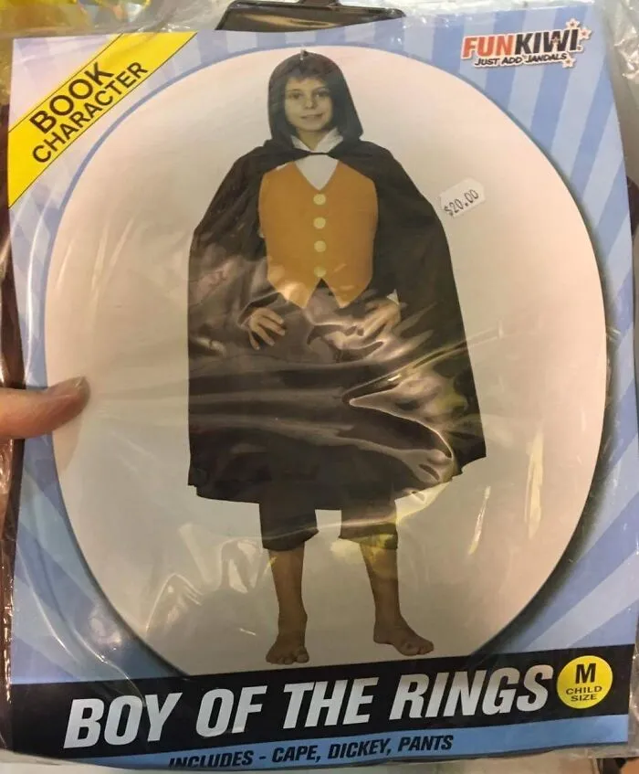 Child wearing an off-brand Halloween costume called Boy of the Rings, featuring a cape and vest in a boxed package.