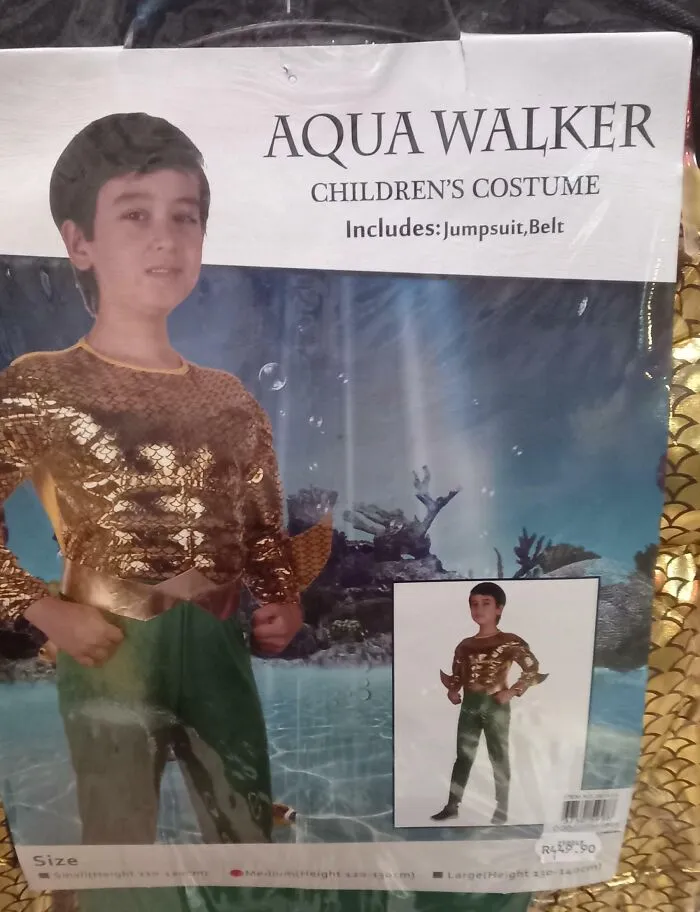 Child in an off-brand Halloween costume called Aqua Walker with gold jumpsuit and green pants underwater background.