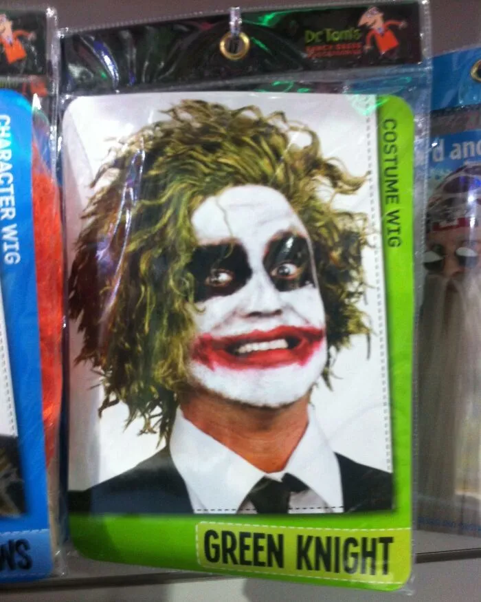 Off-brand Halloween costume wig with messy green hair and white face paint with black and red details.