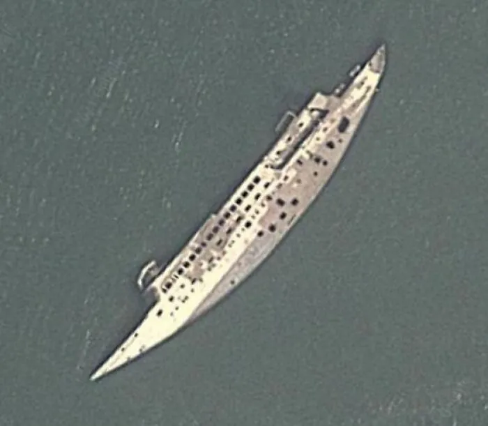 Aerial view of a sunken shipwreck captured on Google Earth revealing an unexpected maritime scene.
