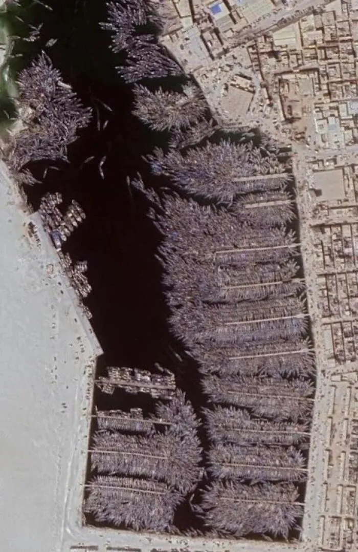 Aerial view captured on Google Maps showing an unexpected dense cluster of boats tightly packed in a harbor.