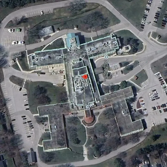 Aerial view of a large health center captured on Google Earth revealing unexpected map details and surrounding parking areas.