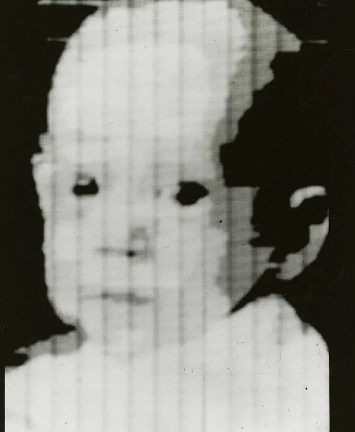 Old black and white photo of a baby, an example of early photography that survived from a new phenomenon era.