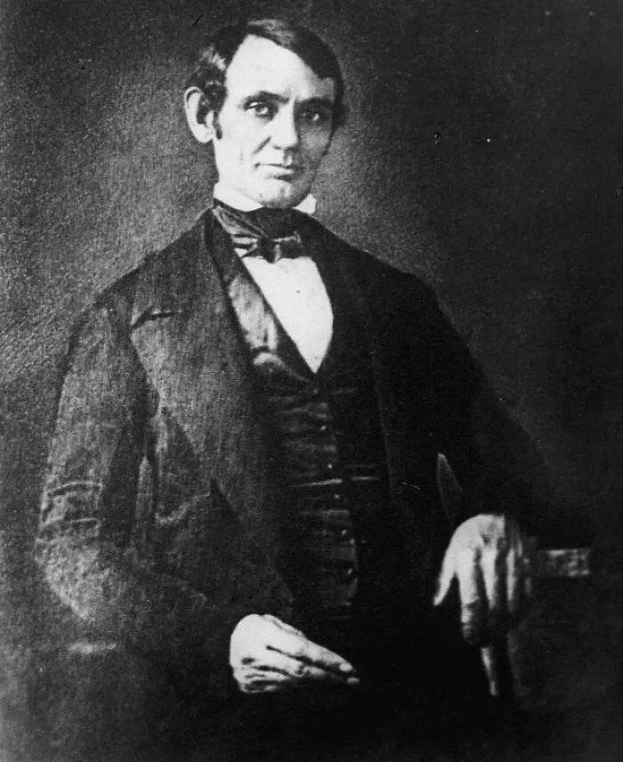 Black and white vintage portrait of a man in formal 19th century attire from early photography era.