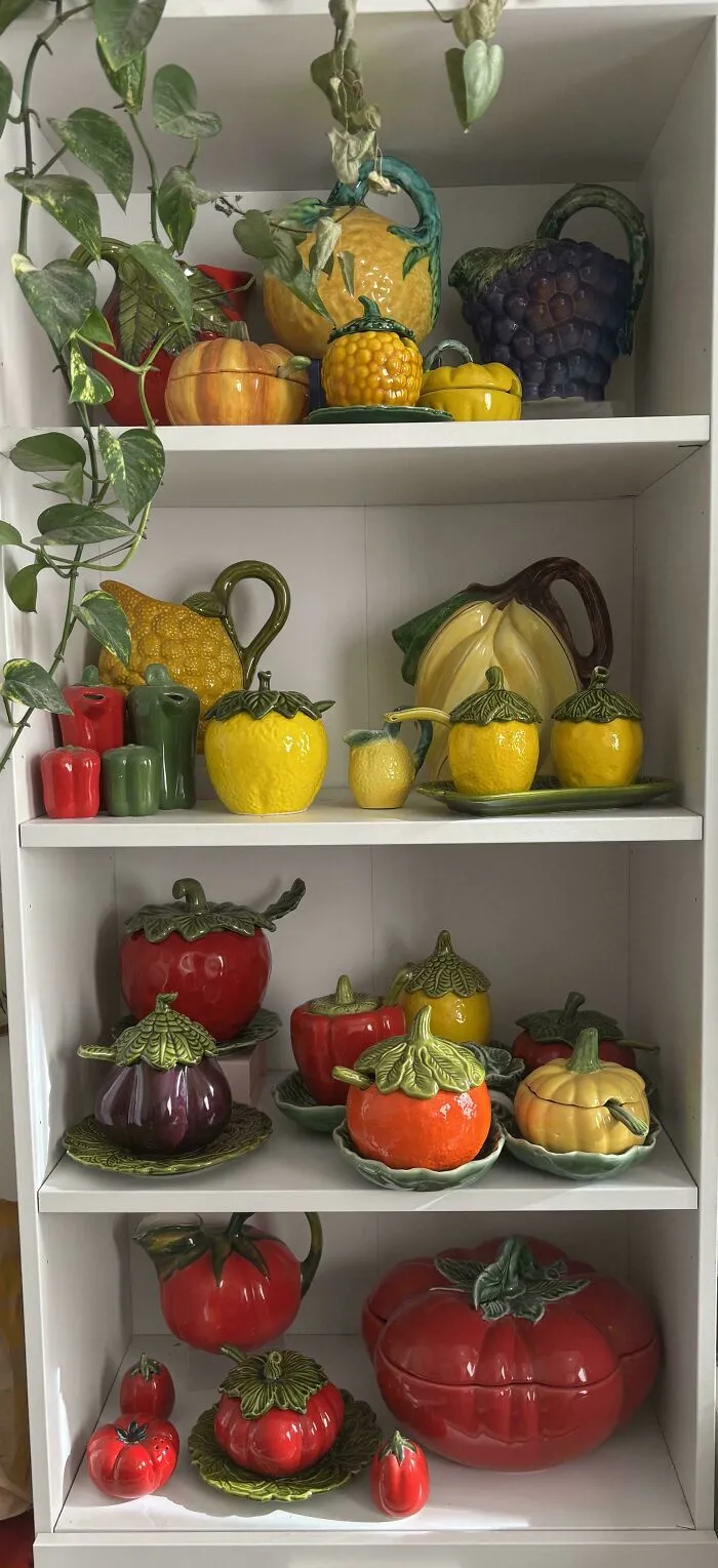 Ceramic fruit and vegetable decor pieces displayed on shelves, showcasing cottage core aesthetics with vibrant colors.