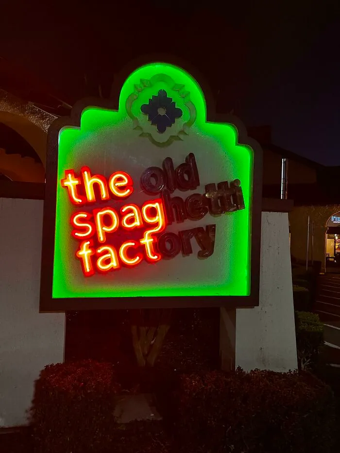 Neon LED sign for The Old Spaghetti Factory with red and green lighting glowing at night.