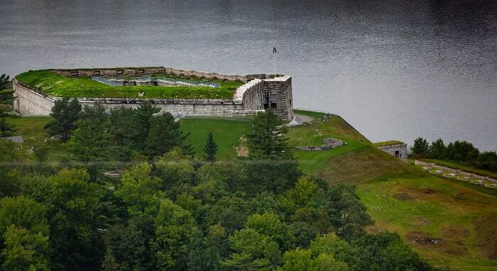 Historic fort surrounded by water and dense forest, a spooky destination perfect for Halloween exploration and haunting adventure.