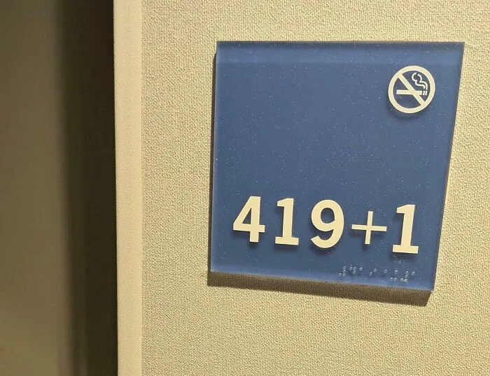 Room number sign showing 419+1 with no smoking symbol, an example of moderately interesting details people share.