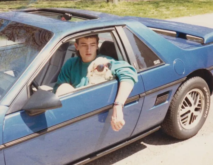 I Humbly Submit A Photo From Circa 1987 For Your Approval. A Photo Of Me, My Dog Wearing Sunglasses, And My 1984 Fiero SE