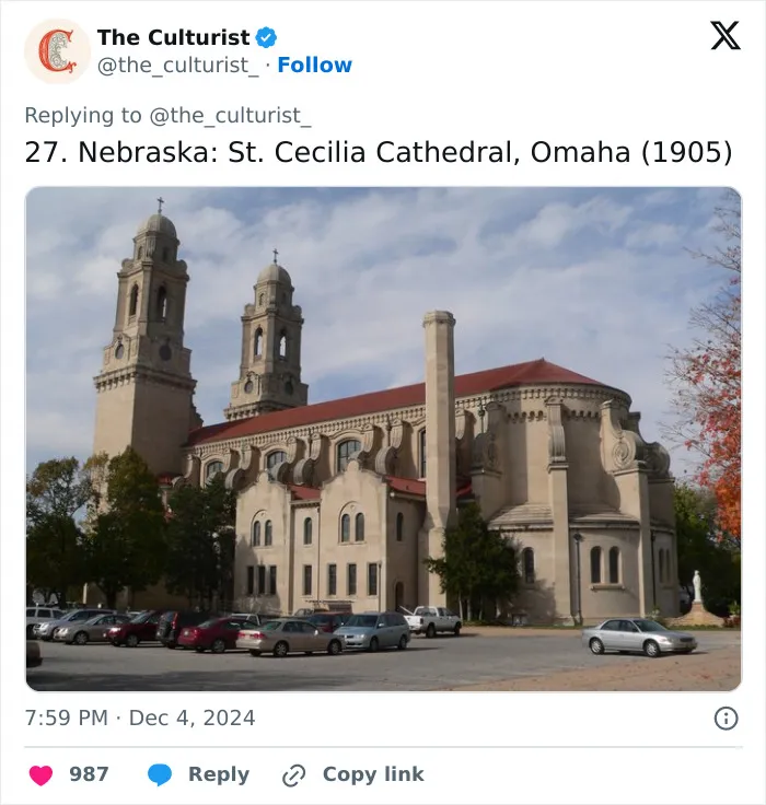 St. Cecilia Cathedral in Omaha, Nebraska, a beautiful and striking church with twin towers under a cloudy sky.