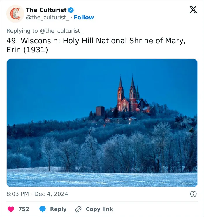 Holy Hill National Shrine of Mary lit at dusk on a hill surrounded by frosty trees, a spectacular church in Wisconsin.