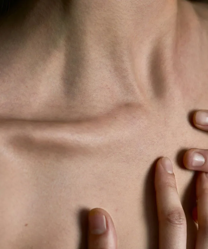 Close-up of a person’s skin and fingers highlighting delicate textures, related to plastic surgeons and unnecessary surgeries.