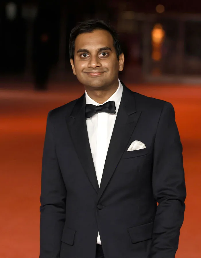 Male star in a black tuxedo and bow tie, attending a formal event, showcasing surprising actual height.
