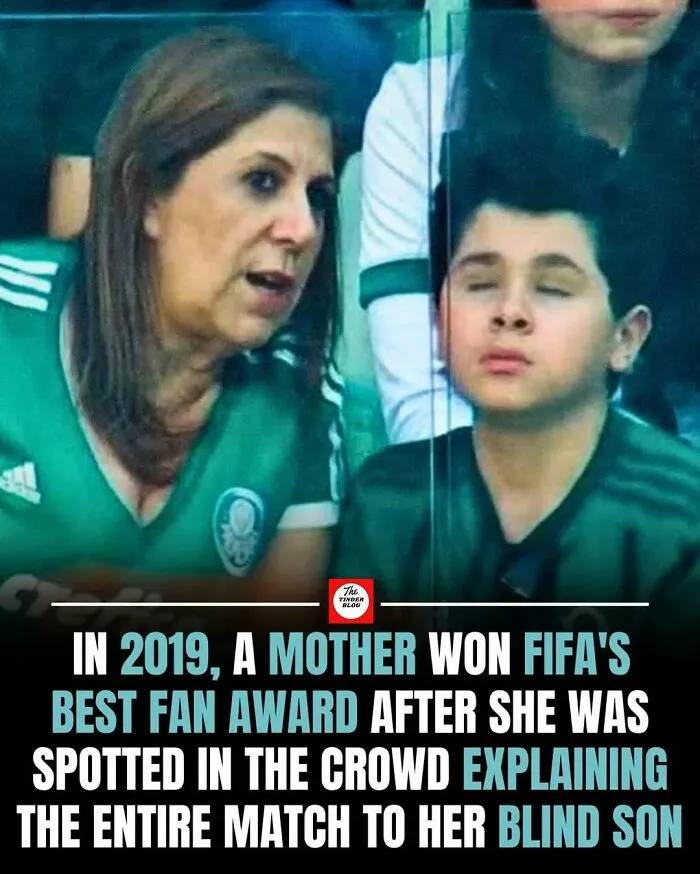 Mother showing wholesome and adorable support by explaining a FIFA match to her blind son in the crowd.
