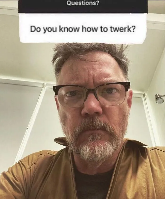 Middle-aged man with glasses and beard looking serious under a question about twerking in posts that hit different at 3AM memes.
