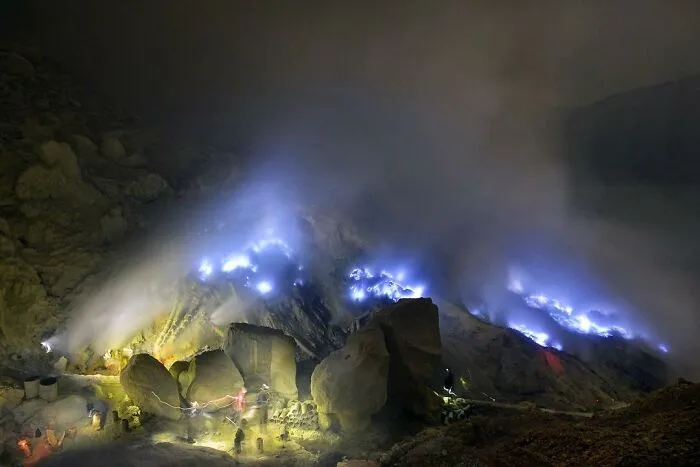 Blue Fire And Sulfur Miner, Ijen's Volcano Caldera, Acidic Water Crater With Ph 0.5 In East Java, Indonesia