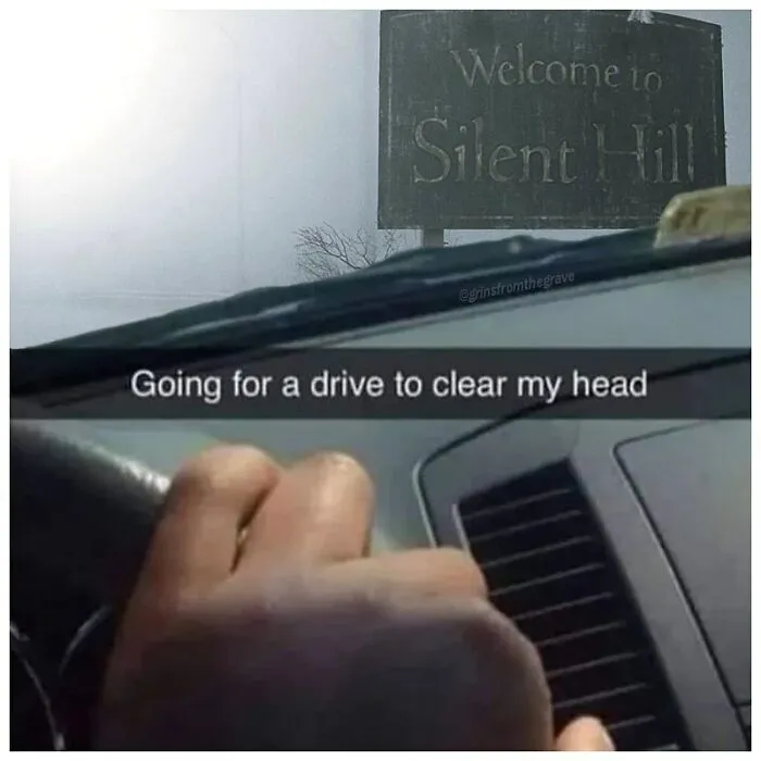 Hand gripping steering wheel driving past a Welcome to Silent Hill sign, a horror movie meme about clearing the head.