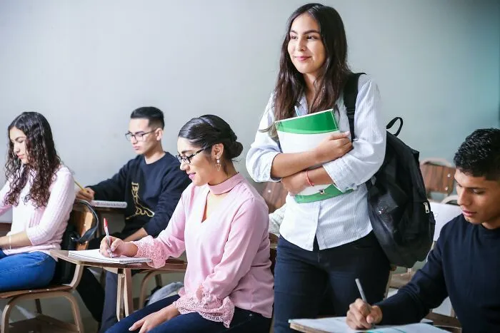 Popular kids in school interacting with classmates, highlighting shocking things that made them outcasts.
