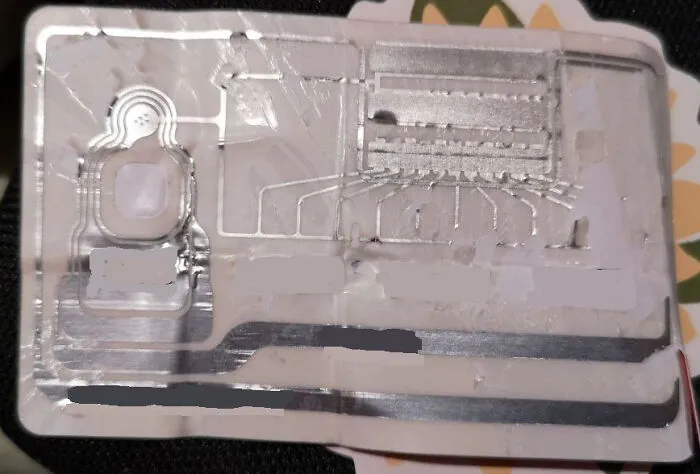 Close-up view showing the insides of a transparent electronic chip with circuits and connectors exposed.