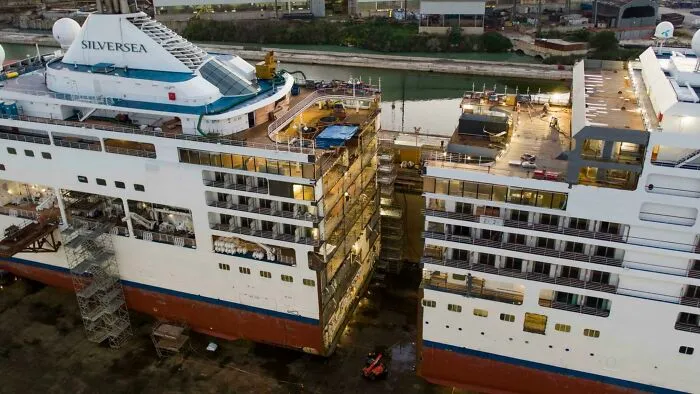 Cutaway view of a large cruise ship showing the insides of different decks and structural details.
