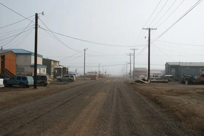Remote dusty road in a small foggy town showcasing one of the mind-blowing remote locations that actually exist.