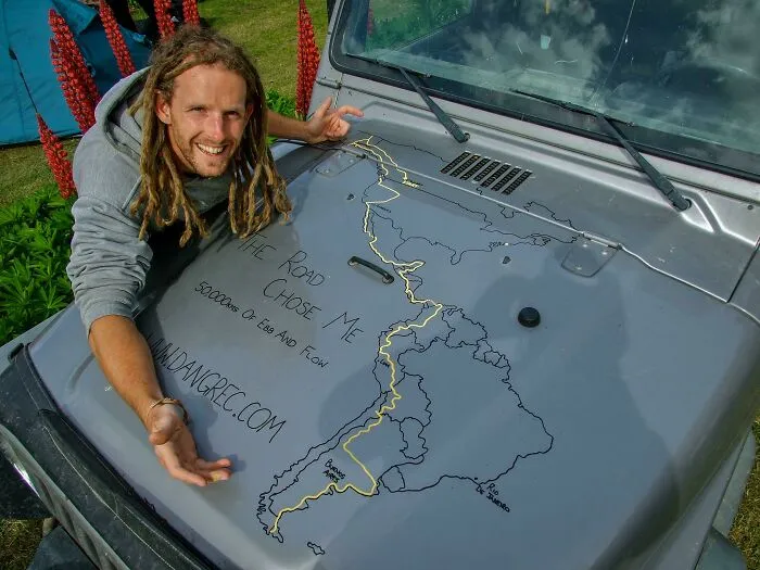 Man with dreadlocks shows travel route drawn on car hood, inspired by turning dreams into reality and inspiring others online