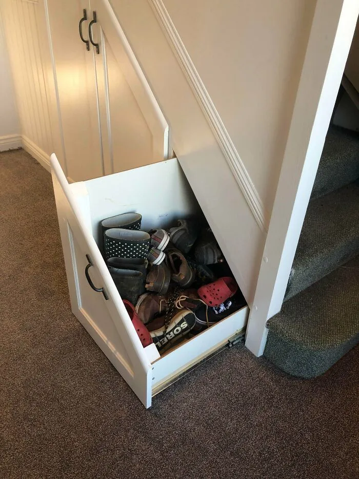 Under stair shoe storage drawer painted white, demonstrating a creative DIY project using paint and patience.