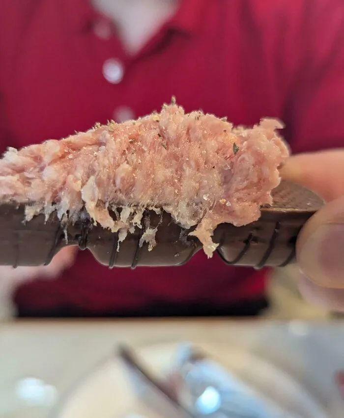 Close-up of a brown crispbread topped with an unappetizing spread, featured in dishes that are just stupid.