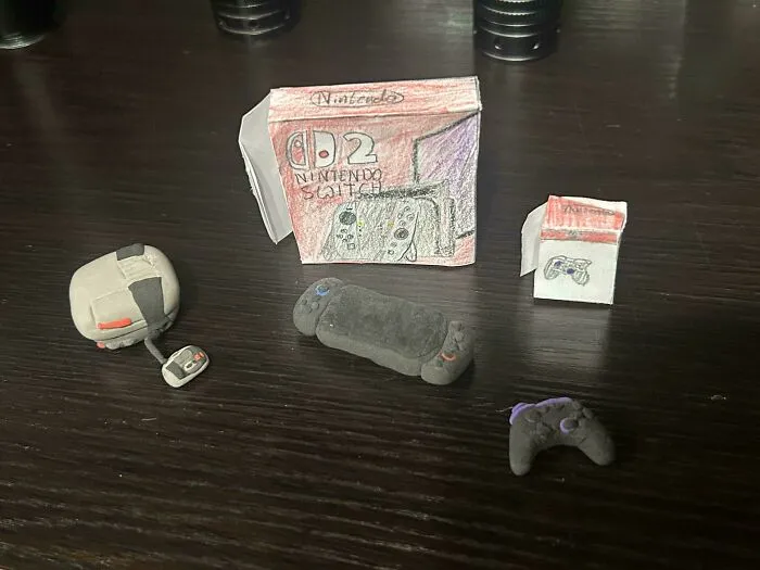 Miniature handmade Nintendo Switch set with controllers and packaging, showcasing wholesome internet moments and creativity.