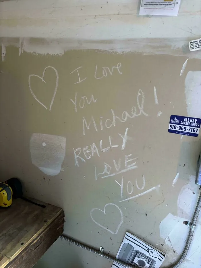 Handwritten message on wall says I love you Michael, really love you with hearts, showing wholesome internet moments of kindness.