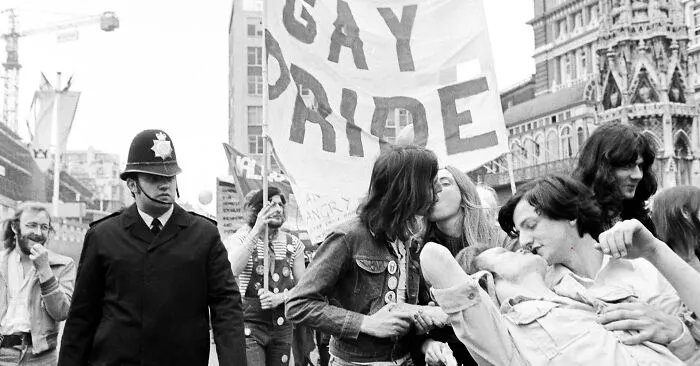 10 Years After The UK Legalised Homosexuality, A Gay Kiss In Public Could Still Lead To Arrest For Public Nuisance. At This Early Pride March, A Police Officer Turns A Blind Eye. London, 1977