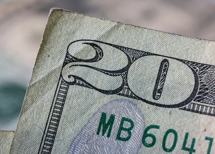 Close-up of a wrinkled 20-dollar bill representing the concept of horrible gifts people have actually received.