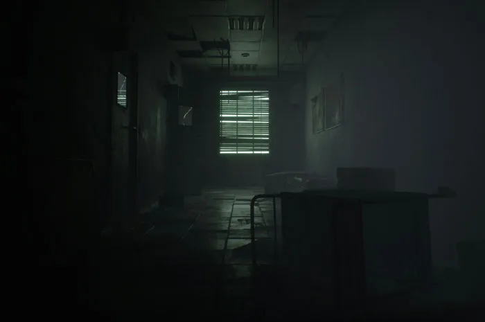 Dark abandoned hallway with broken ceiling panels and scattered furniture, capturing a creepy urban explorer moment.