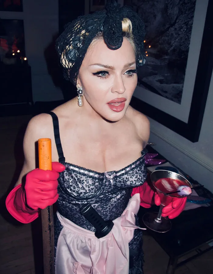 Celebrity in a detailed Halloween costume holding a drink and a prop, showcasing creative Halloween costume ideas.