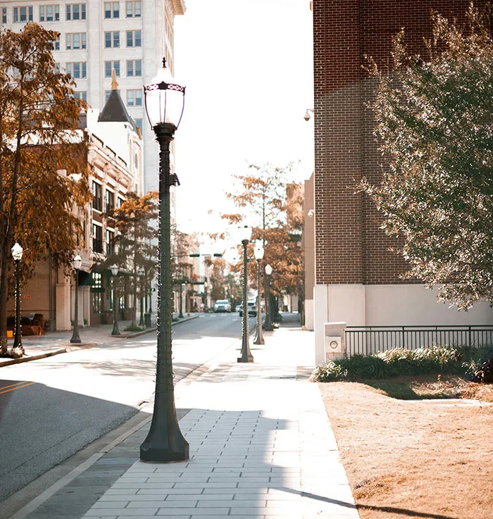Empty urban street with lampposts and autumn trees, highlighting solo female travelers places not recommended.