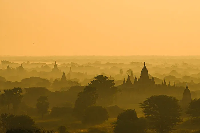 Sunset over ancient temples and trees, illustrating solo female travelers' experiences in places they do not recommend.