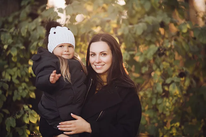 Woman and child outdoors in autumn, portraying themes related to men not wanting to have anything in common with women.