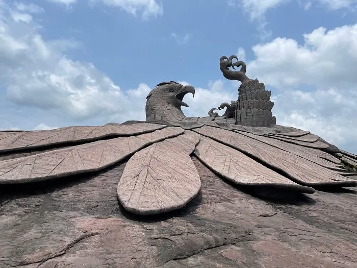 Massive eagle sculpture with detailed feathers under a bright sky, a must-see spectacular sculpture for travel enthusiasts.