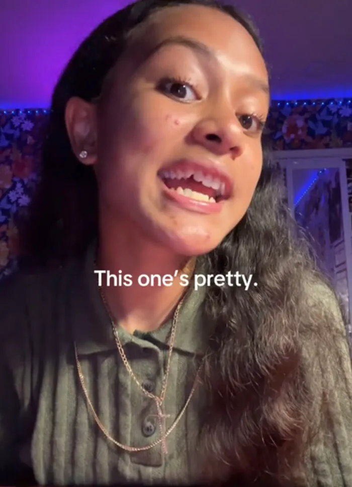 Young woman with natural skin imperfections proudly sharing her smile, embracing perfect imperfections in a wholesome trend.