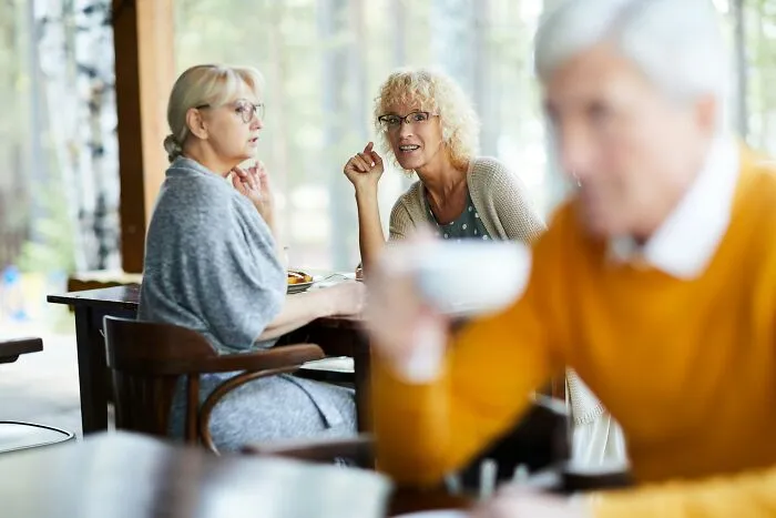 Two women having an intense conversation indoors, illustrating toxic relationship traits and emotional tension.